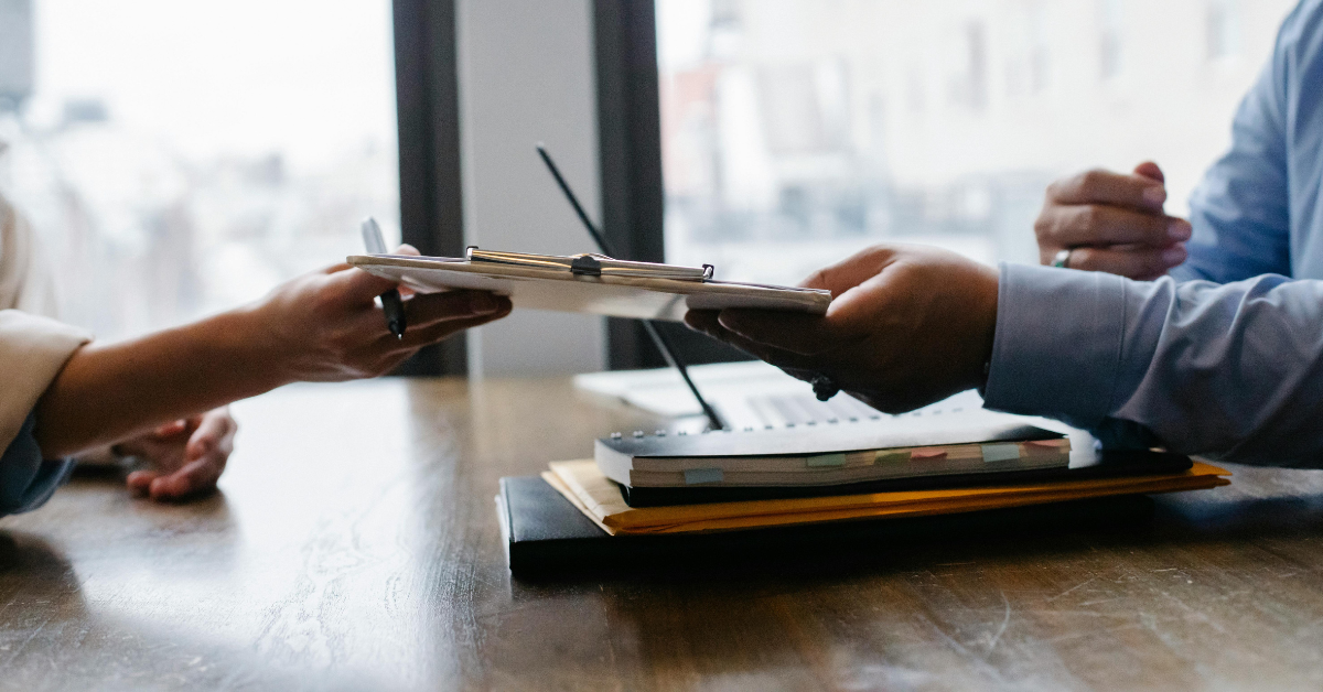 Employer handing new Employee an Onboarding checklist 